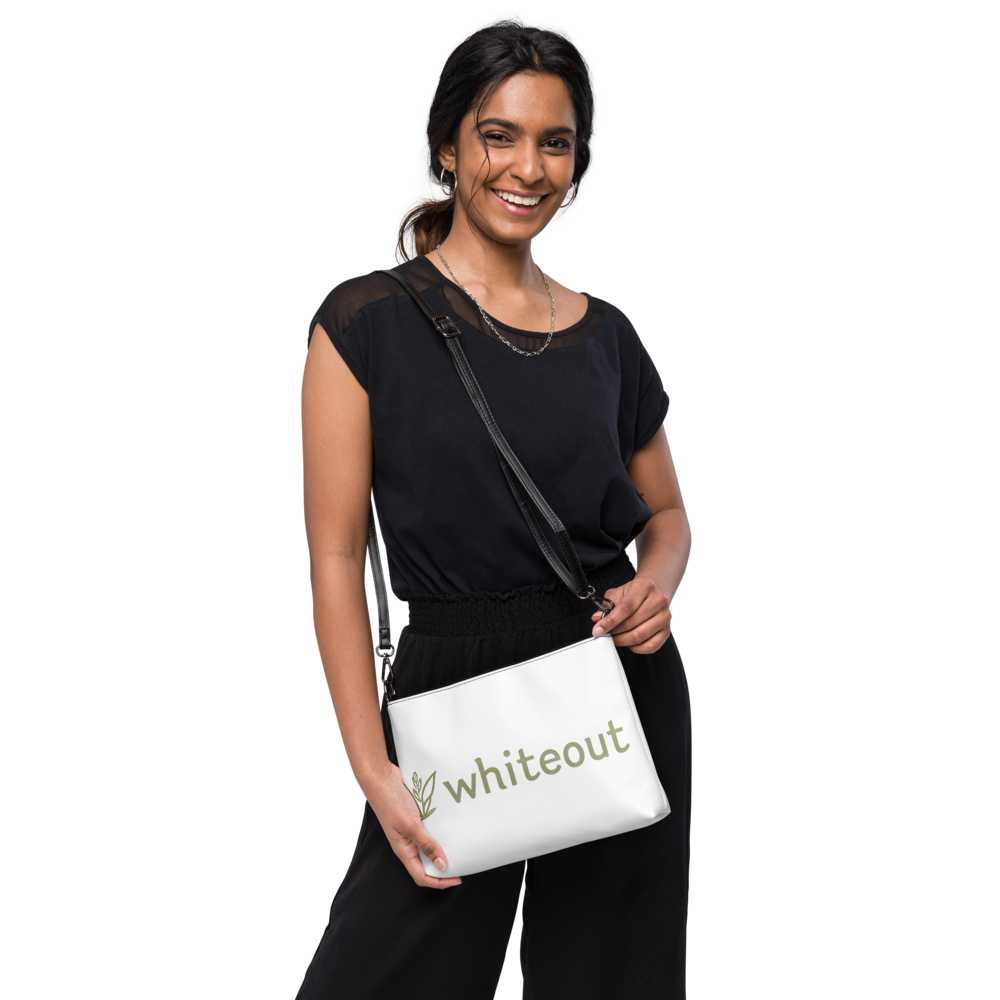 Woman holding a white bag with 'whiteout' branding on a white background