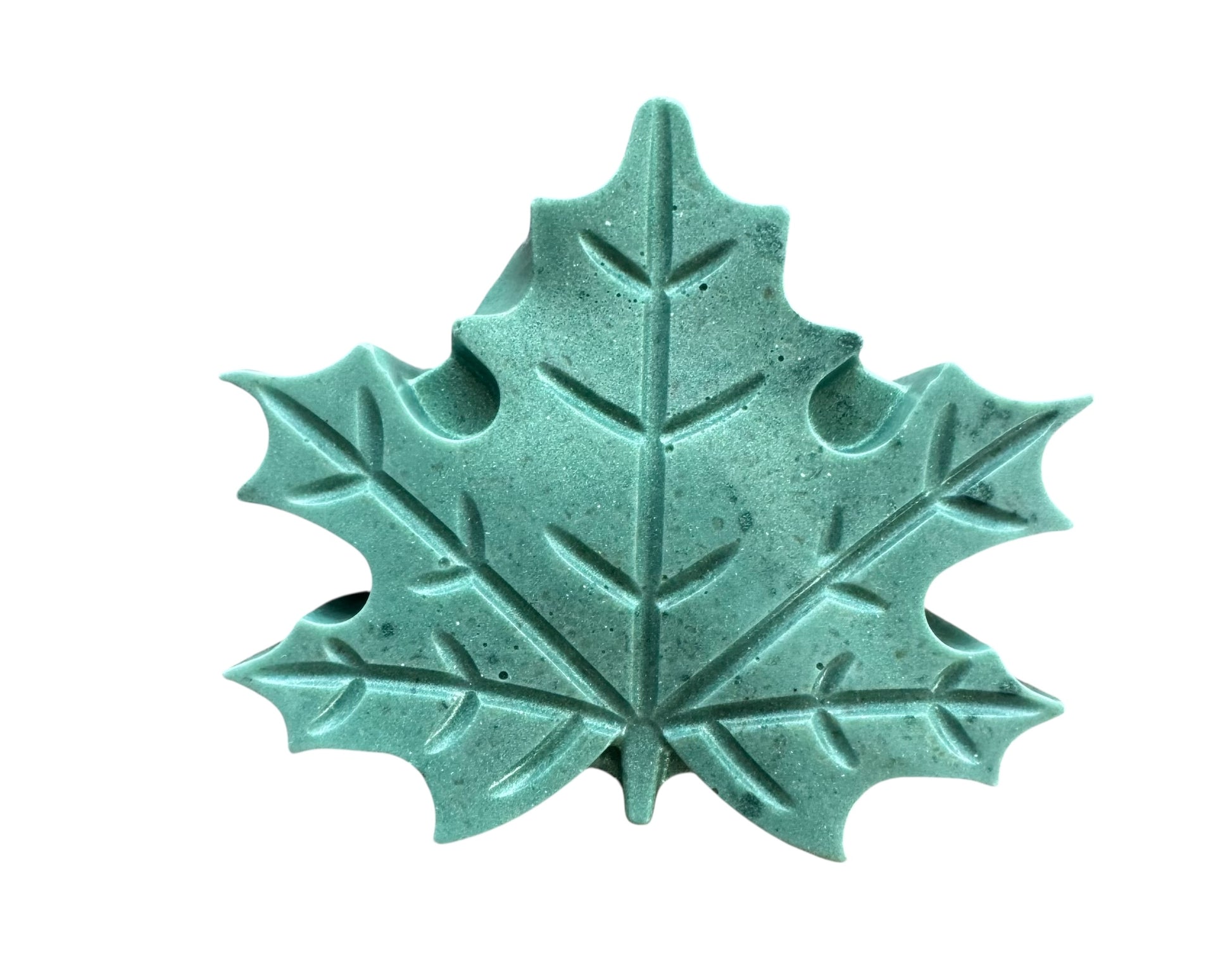 Teal ceramic leaf-shaped object on a white background