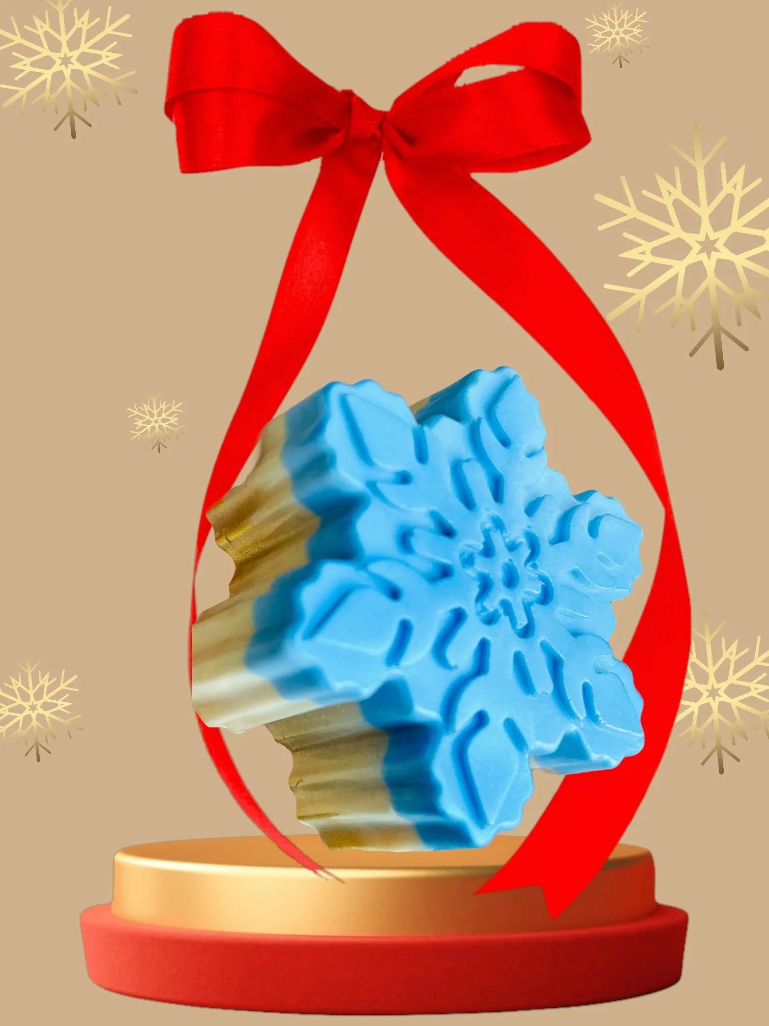 Blue snowflake-shaped object in a clear holder with a red ribbon on a beige background with gold snowflakes.