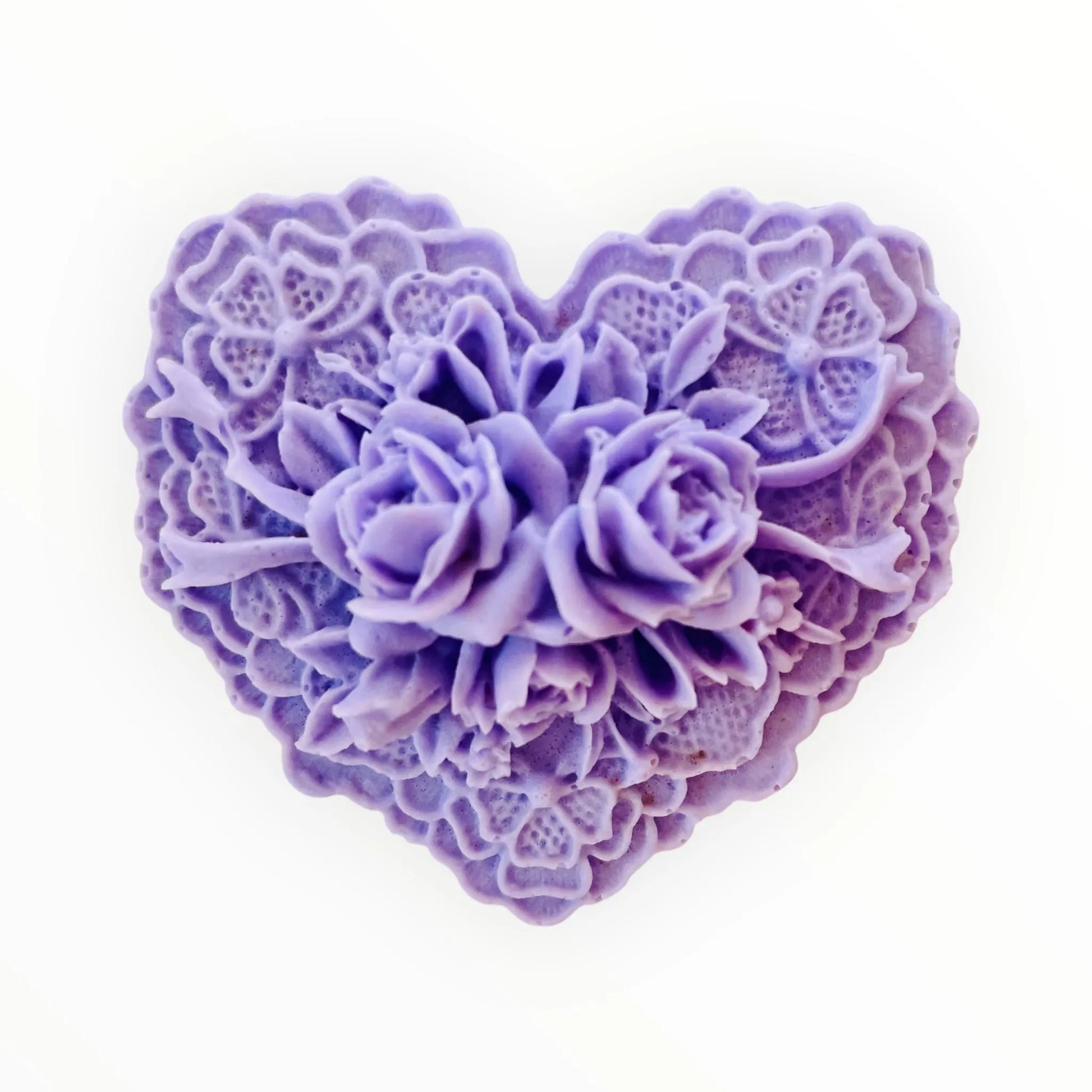 Heart-shaped purple floral soap on a white background