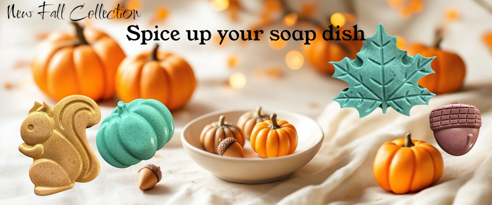 Decorative soap dishes shaped like pumpkins, a squirrel, and acorns on a soft surface with pumpkins in the background.