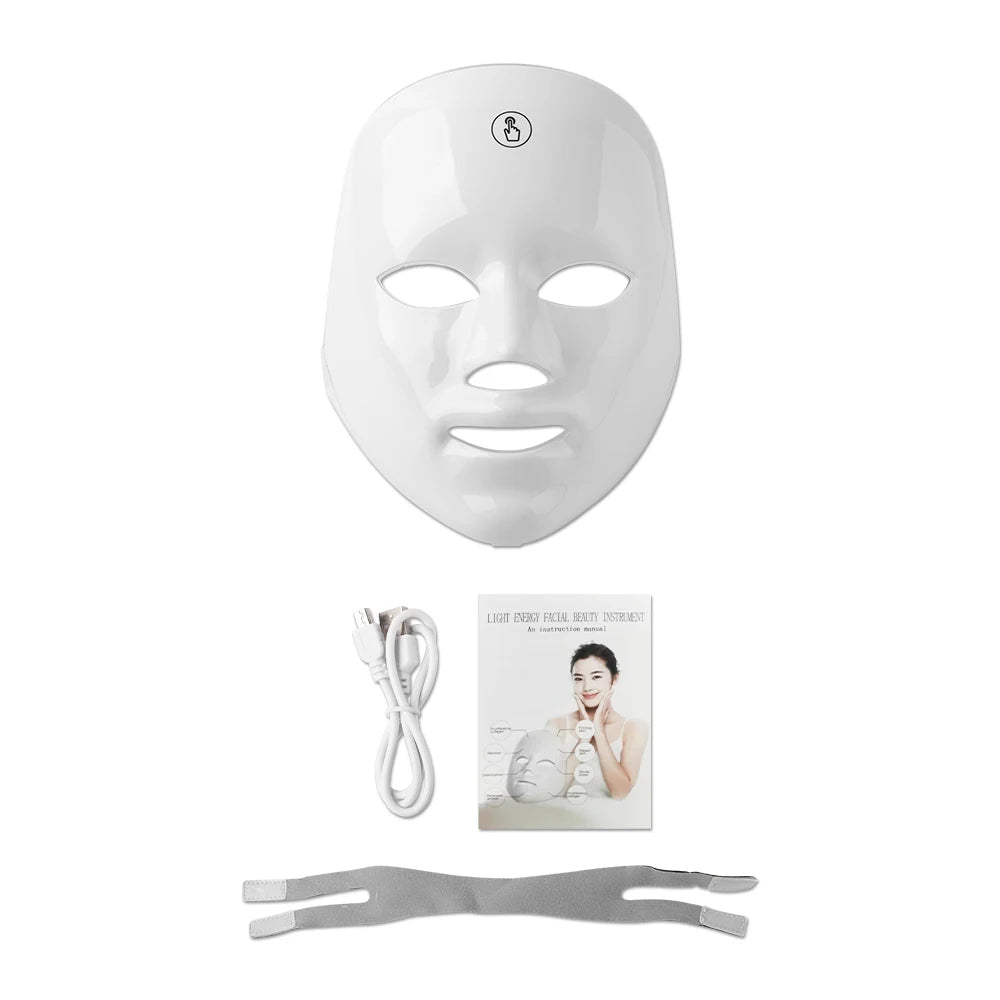 White LED face mask with cable, strap, and user manual on a white background