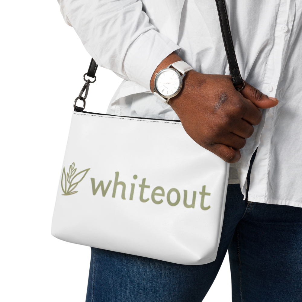 Person holding a white bag with 'whiteout' branding