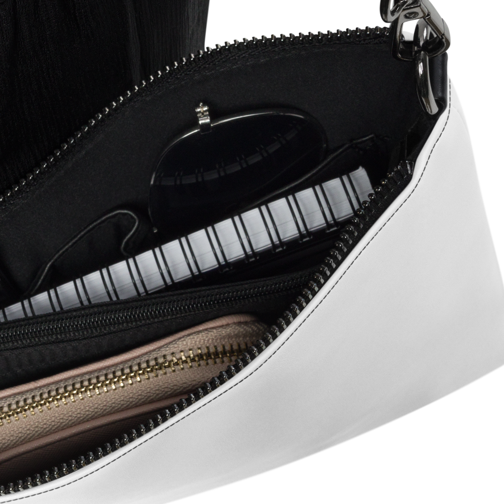 Close-up of a handbag with zippers and a visible brand logo on a white background