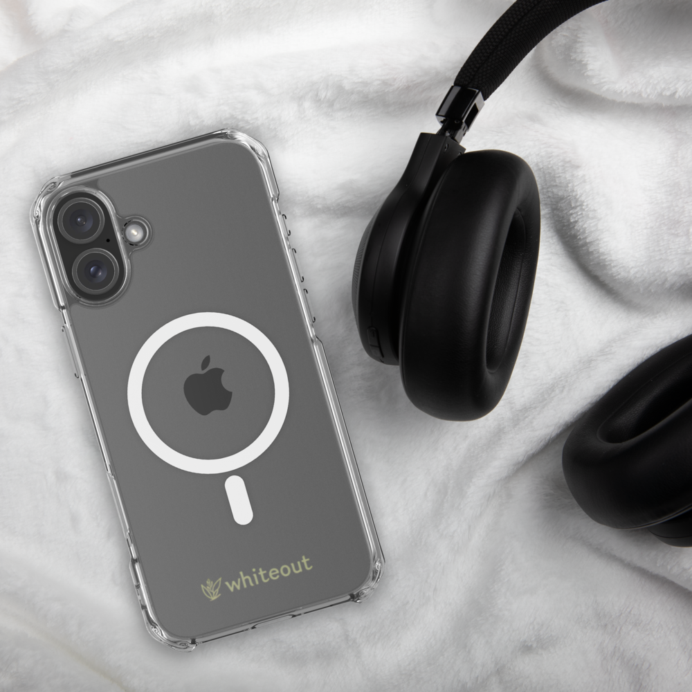 Clear phone case with Apple logo and 'whiteout' branding next to black headphones on a light gray background