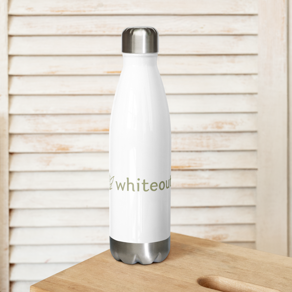 White insulated bottle with silver lid on a wooden surface against a wooden slatted background